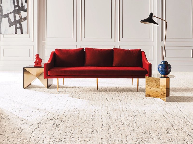 red couch on white carpet - Economy Carpet Inc