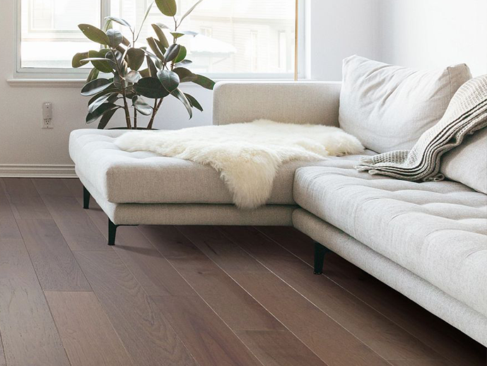 beige corner couch on hardwood floor - Economy Carpet Inc